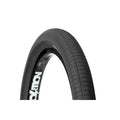 Close-up of a black Demolition HammerHead S 20 Inch Tyre featuring a textured tread pattern, partially mounted on a rim against a white background. This wire bead bicycle tire is offered in both 2.25 and 2.4 inch widths, providing durability and dependable grip for diverse riding conditions.