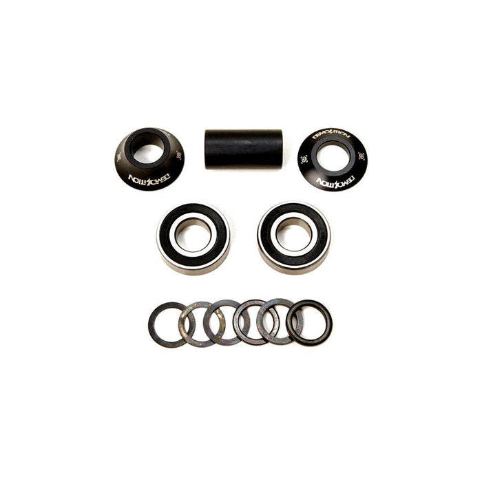 The Demolition MID Bottom Bracket set, featuring two cups, mid BB sealed bearings, a tube, and washers, is neatly displayed on a white background.