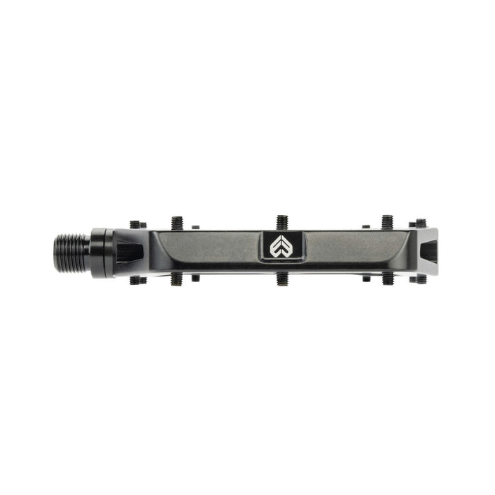 Description: The Eclat Surge XL Pedal features a single bicycle pedal with a black metal body, an oversize platform area, and a dual bearing/bushing spindle system. Multiple small bolts adorn its top surface for enhanced grip.