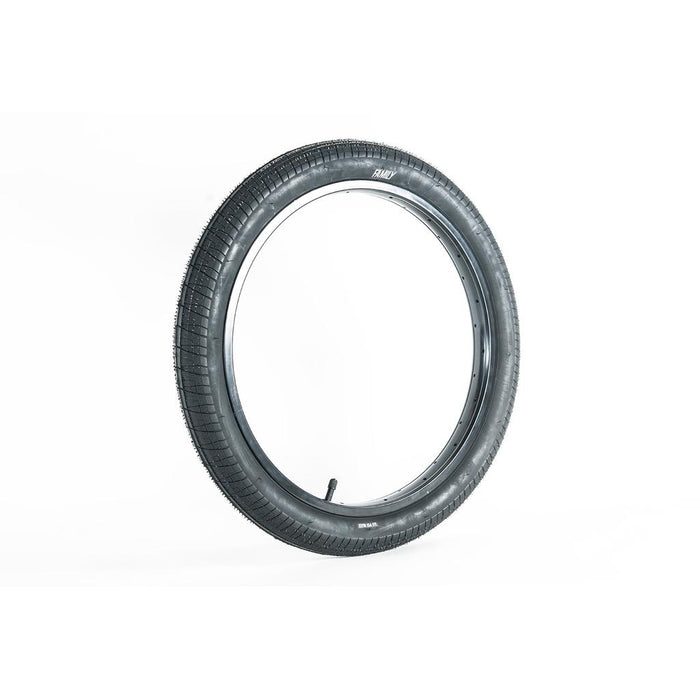 A Family BMX F603 20 Inch Tyre in black stands upright on a white background.