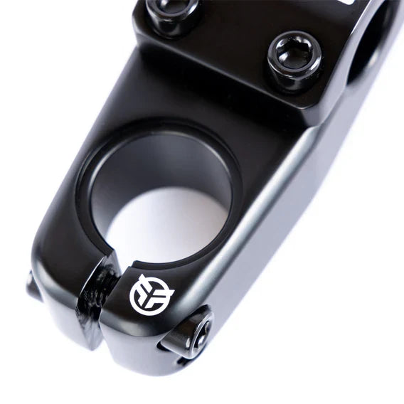 Close-up of a black Federal Element V2 Top Load Stem (22.2mm Clamp), crafted from 6061 aluminium, featuring four bolts and a white logo on the side, set against a white background.