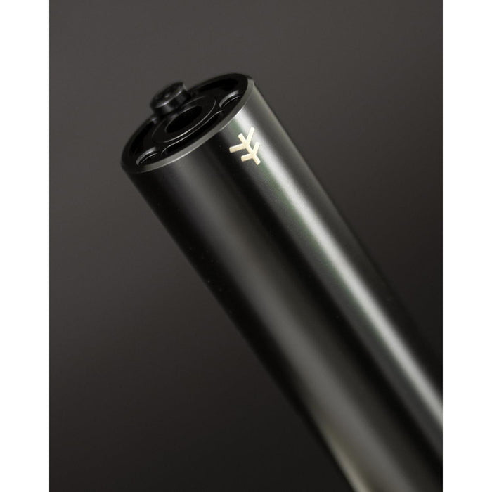 Close-up of the sleek black Fly Bikes Acero ST Peg, expertly CNC machined from 4140 Cr-Mo, featuring a subtle logo on its surface, against a dark background.