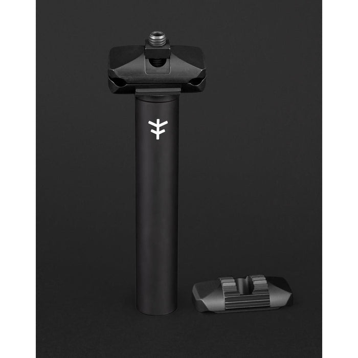 The Fly Bikes Motosierra Railed Seat Post is a sleek black cylindrical post made of CNC machined 6061-T6 aluminum, featuring a logo and an accompanying bracket. Ideal for those who value durability and precision in a ripper seat post.