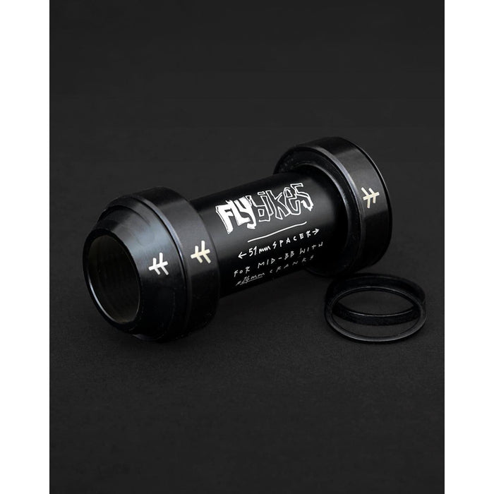 The Fly Bikes Rotar BB features CNC machined aluminum with white text and symbols on a dark surface, elegantly complemented by two neatly placed O-rings.