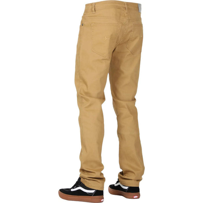 A person wearing FP Pants Relaxed Fit Chino Bone made from stretch fabric and black sneakers with white laces and brown soles is shown from the back.