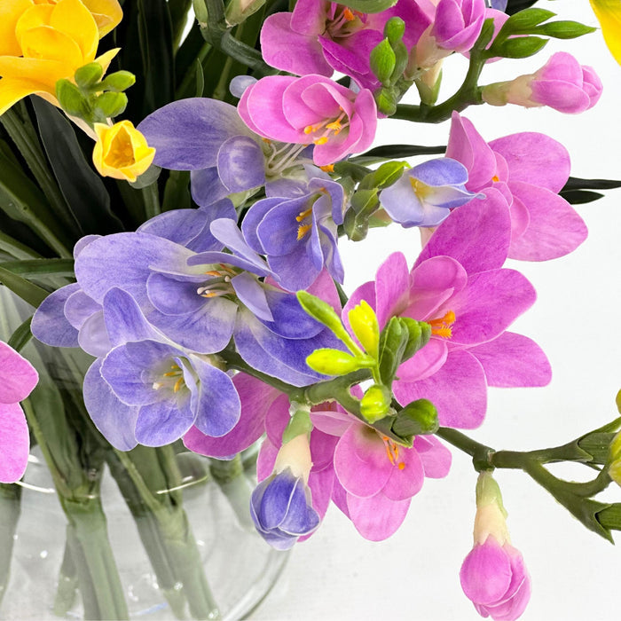 Freezia Mix Silk Flower Arrangement in Glass Vase. Close up view. Arrangements available from www.plantcouture.co.za