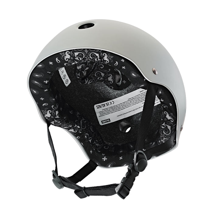 Gray Goodstock Certified Helmet / Matte Gunmetal/Bandana with an intricate black and white interior design and a chin strap, featuring a label with specifications. This certified skate/bike helmet offers high and low impact protection, along with CoolMax liner tech for added comfort.