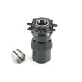 A black gear mechanism with a toothed sprocket, reminiscent of Kink Bikes' intricate designs, is connected to a cylindrical body. It sits beside a small metal sleeve against a white background, mirroring the precise design of the Kink East Coaster Driver and Clutch system.