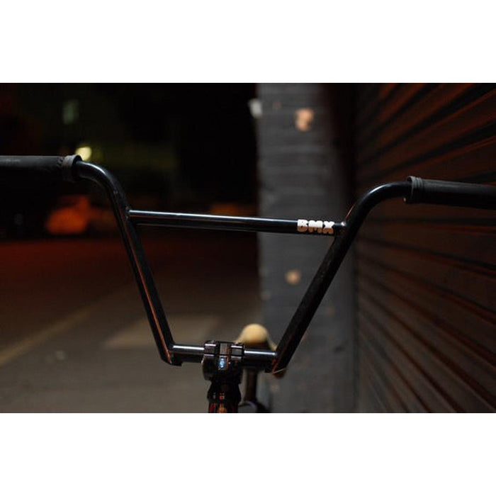 A close-up of Kink Williams 4-Piece Bars featuring a TruTherm post weld construction, shown at night against a dark wall with a blurred background.