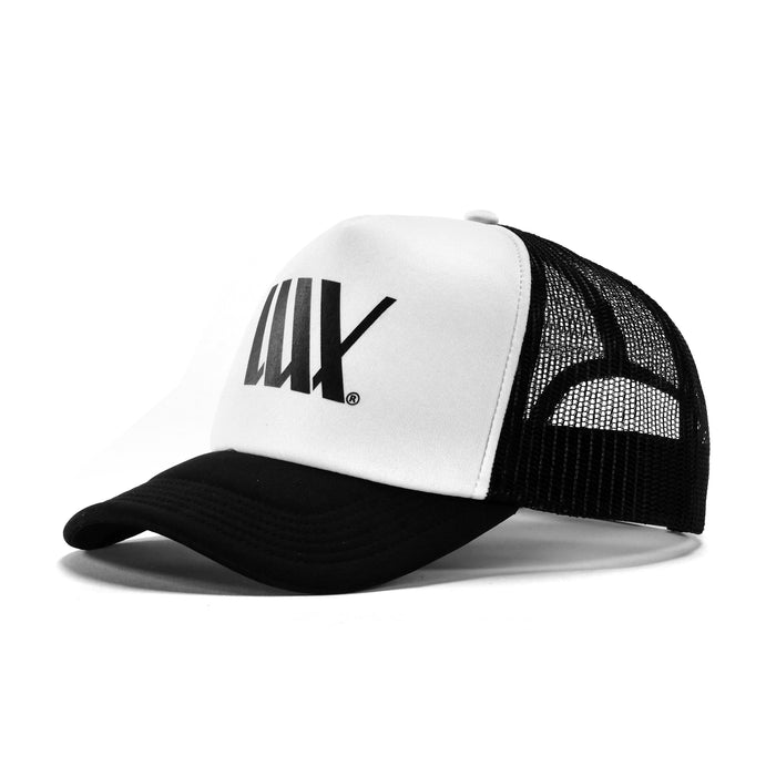 The LUXBMX Flag Trucker Cap features bold "LUX" lettering, a black and white design with black mesh back, and is crafted from recycled polyester—ideal for stylish days out in Brisbane.