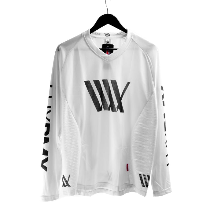 The LUXBMX Race Jersey White V2 features a bold black logo on the front and is displayed on a black hanger with a plain white background.