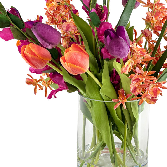 Close up Bouquet of mixed colorful flowers in a clear vase on a white background