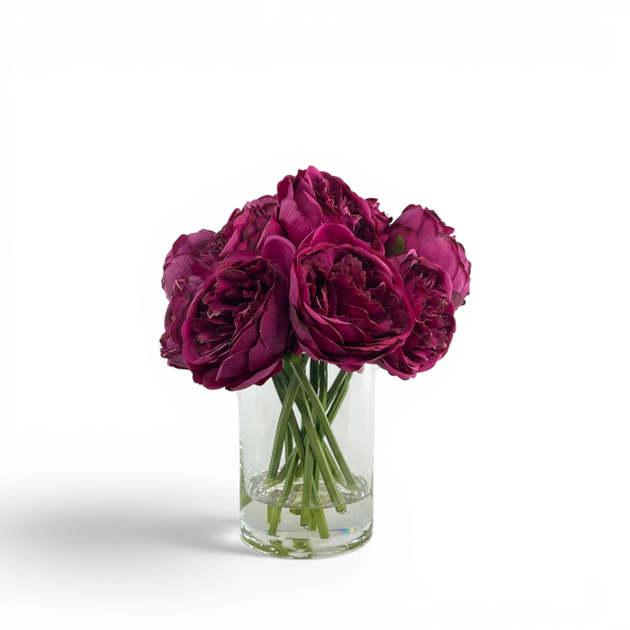 Faux Purple Peony stems in a clear glass vase