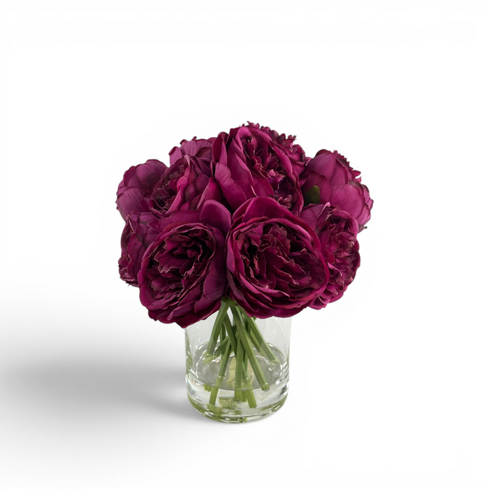 Artificial Purple Peony stems in a clear glass vase with artificial water
