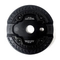 A circular, black mechanical component with four screws, labeled "PRIMO PARTS COMPANY" and "DESIGNED IN LBC, CA." The lightweight durable Primo Omniguard Sprocket features ridged detailing, a central hole, and an optional bolt-on replaceable nylon guard.