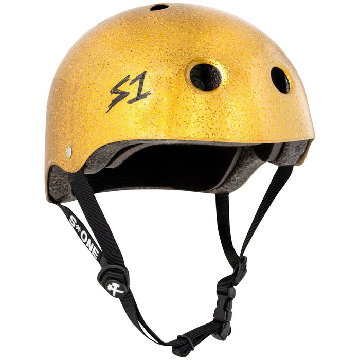 A shiny yellow S-One Helmet Mini Lifer Gold Gloss Glitter with ventilation holes, black straps, and an adjustable buckle. Made with EPS Fusion Foam for superior protection, the helmet features a logo with the letter 'S' and the number '1' on one side.