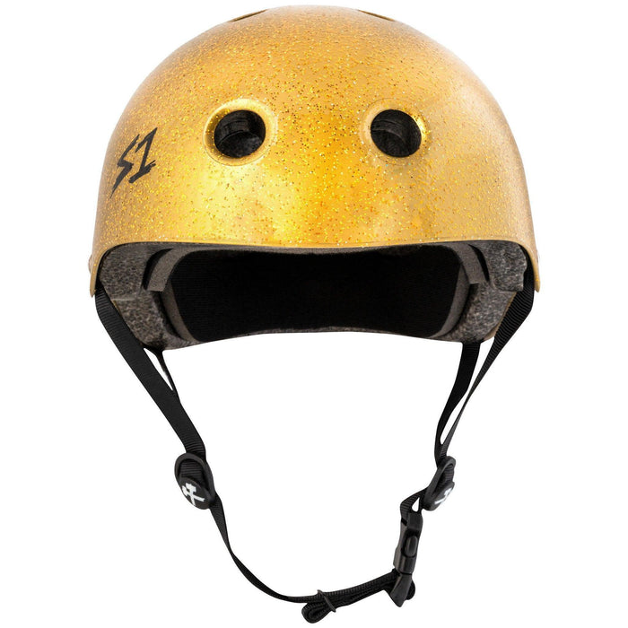 Close-up of an S-One Helmet Mini Lifer Gold Gloss Glitter featuring a gold-colored shell with black interior cushioning, two round front ventilation holes, and an adjustable black chin strap made of EPS Fusion Foam for added safety.