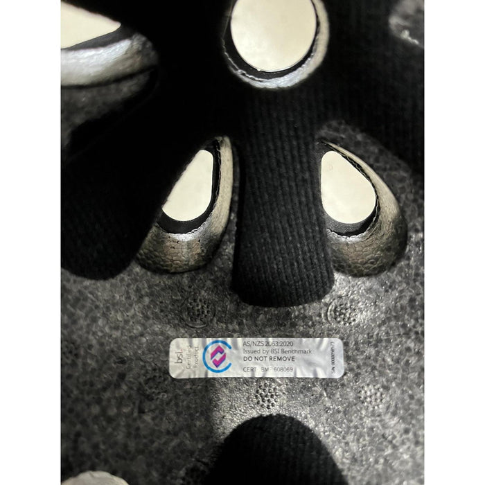 Interior of the S-One Lifer Helmet / Black Matte/Cyan Straps showing a compliance sticker with AS/NZS 4330:2020 certification issued by BSI Benchmark.