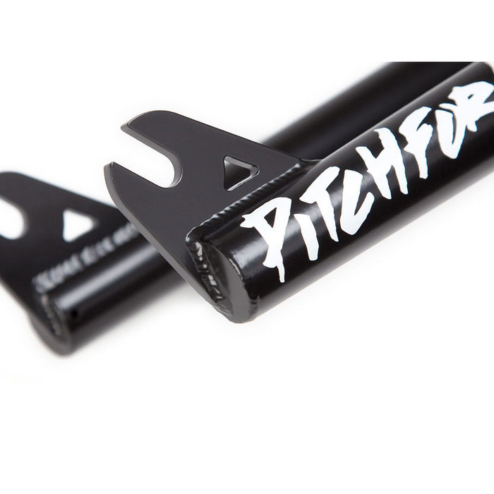 Close-up of the CNC-machined dropouts on a black fork from the S&M Pitchfork XLT 14 Inch, crafted from double-butted 4130 CrMo steel, with "PITCHFUR" elegantly written in white on the side.