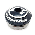 A metallic cylindrical object with the label "STAYSTRONG" in white letters, featuring a circular design at the top surrounded by additional white markings. Designed for a 1.1/8" Integrated Frame, this Stay Strong Integrated Icon Headset includes sealed bearings for superior performance and durability.