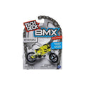 The Tech Deck BMX Bike from the "We the People" Series 16 is a vibrant yellow replica with black accents, recommended for ages 6+. Warning labels are clearly displayed on its packaging for safety. Each model is sold individually and features detailed craftsmanship.