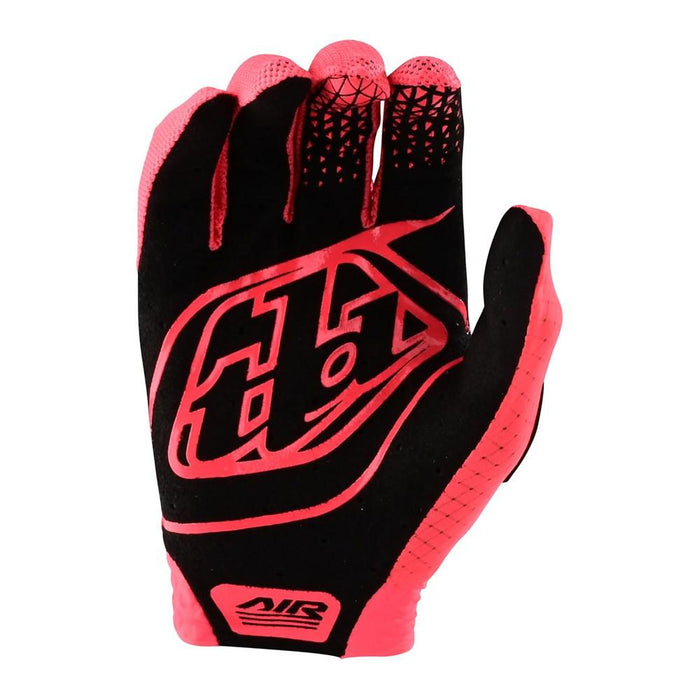 The TLD Youth Air Glove Glo Red is a vibrant mountain bike glove with red and pink tones, geometric grip patterns on the fingertips, and a bold Troy Lee Designs logo on the back of the hand.